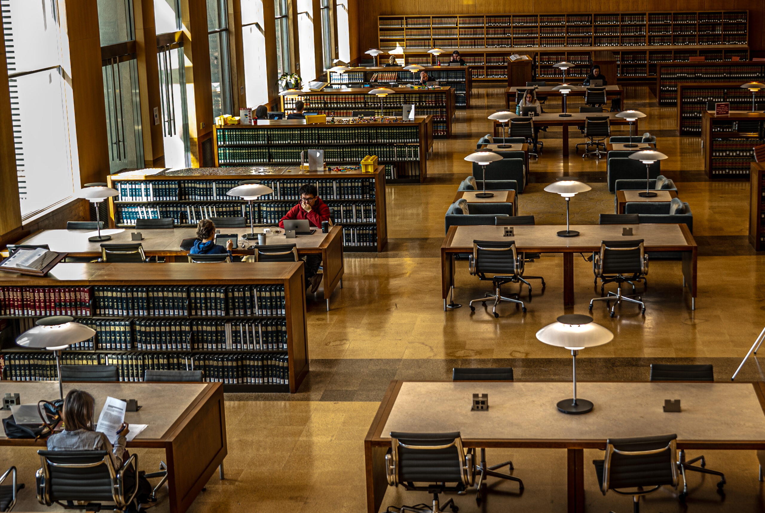 interior of a large law library with many books and large tables for studying